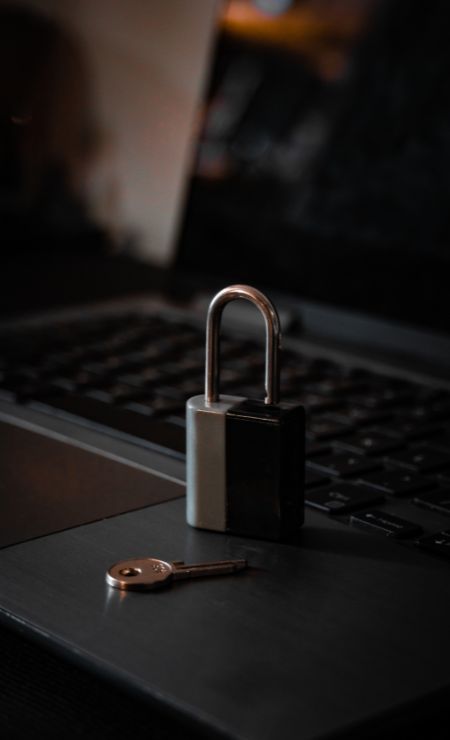 Cybersecurity checklist and padlock on laptop illustrating business protection