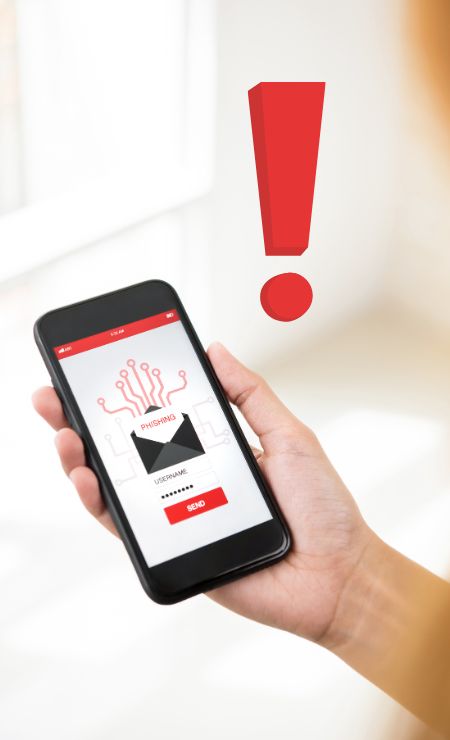 Hand holding smartphone displaying phishing email alert and warning sign.