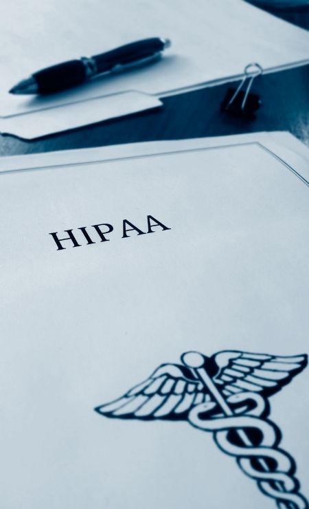 HIPAA document with caduceus symbol, emphasizing the importance of healthcare compliance and patient data protection.