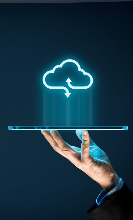 Hand holding a transparent tablet with a glowing cloud symbol above, representing cloud computing benefits and data storage solutions.