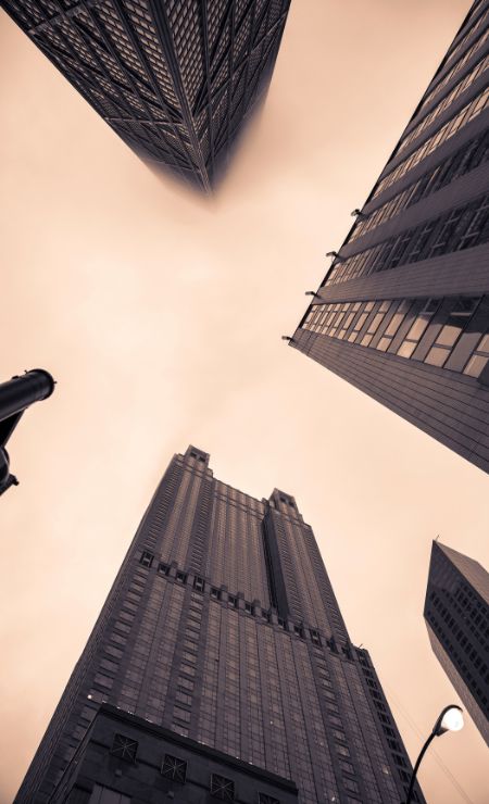 Cityscape featuring towering skyscrapers and a cloudy sky, illustrating urban resilience and infrastructure, relevant to business continuity and disaster preparedness themes.