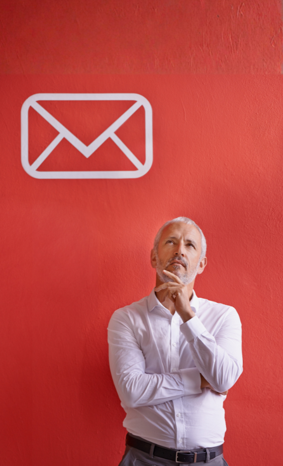 Man contemplating email security against a vibrant red background with an envelope icon, representing email compromise risks for businesses.